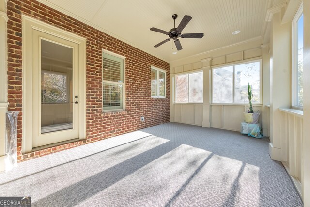 sunroom featuring ceiling fan