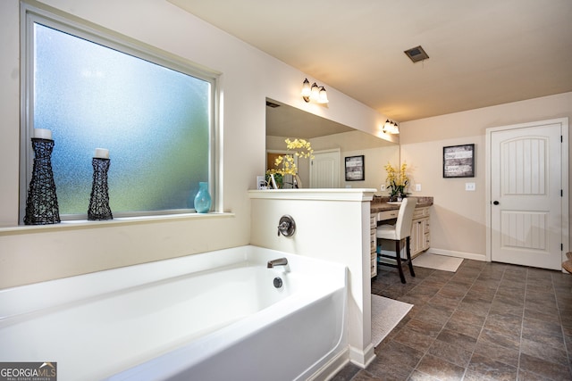 bathroom featuring vanity and a washtub