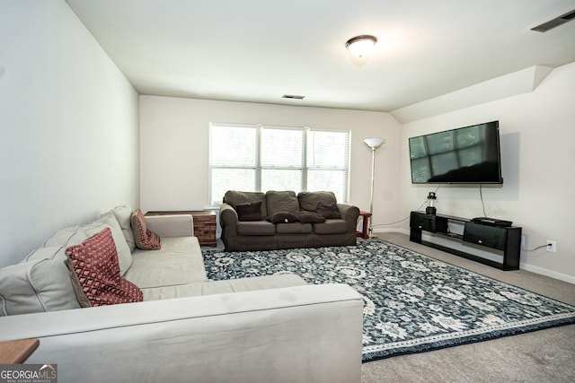 carpeted living room with lofted ceiling