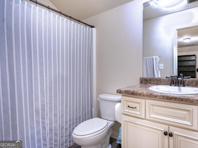 bathroom with vanity, toilet, and curtained shower