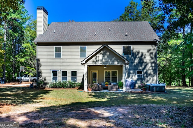 back of house featuring an outdoor living space, a lawn, a patio, and ceiling fan