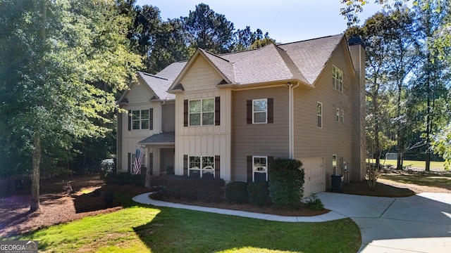 view of front facade featuring a garage, central AC, and a front yard