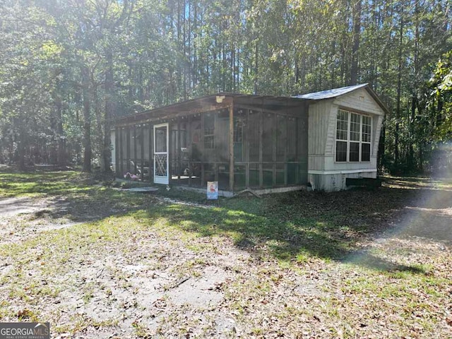 view of outbuilding featuring a sunroom