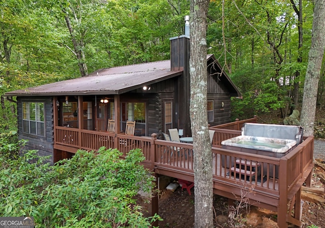 wooden deck featuring a hot tub