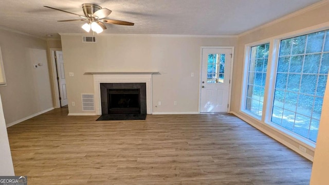 unfurnished living room with ornamental molding, a textured ceiling, light wood-type flooring, and ceiling fan