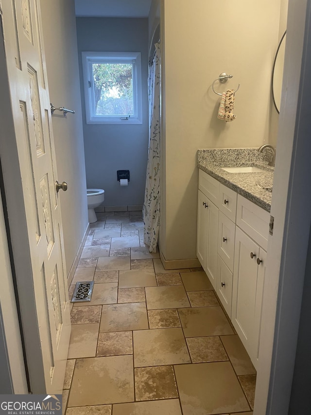 bathroom with vanity and toilet