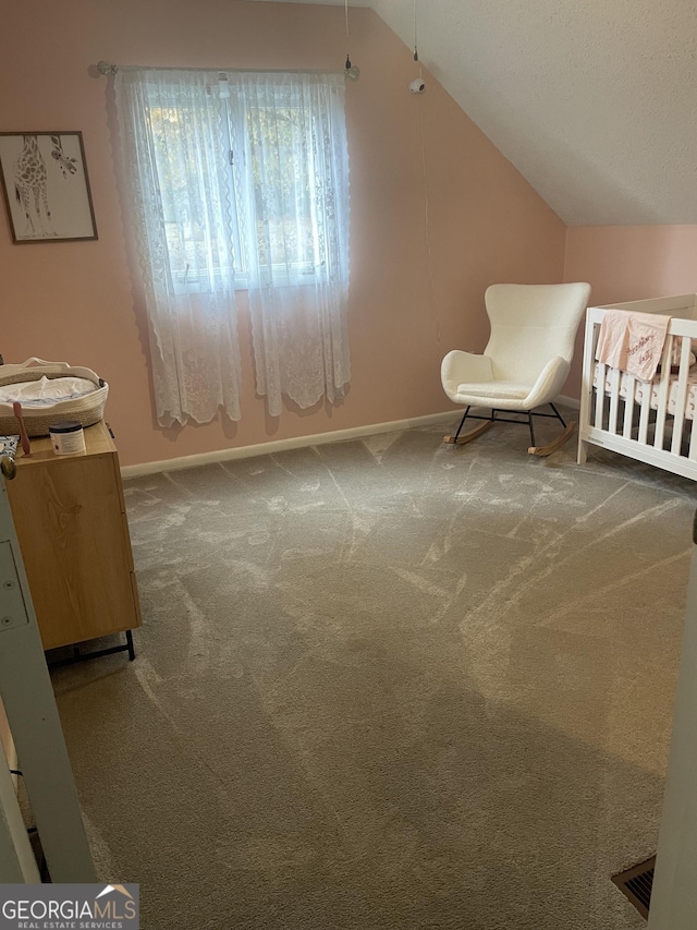 bedroom with carpet flooring and lofted ceiling