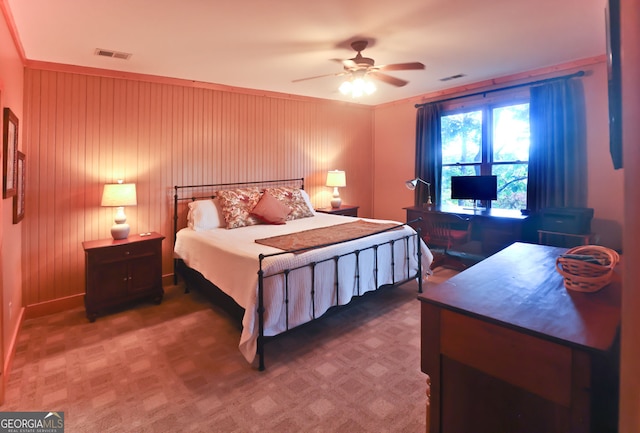 bedroom featuring ceiling fan and wood walls