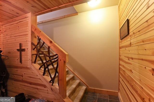 stairs featuring wood ceiling, tile patterned floors, and wooden walls