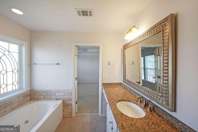 bathroom featuring vanity and a tub to relax in