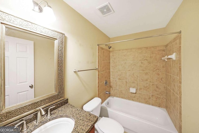 full bathroom featuring vanity, toilet, and tiled shower / bath combo