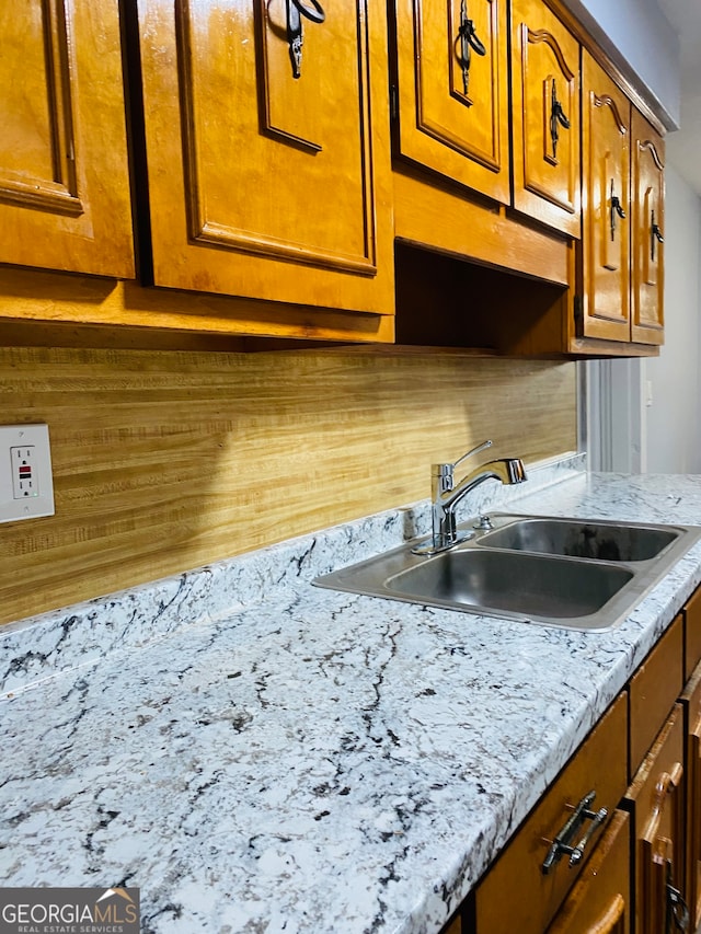 kitchen featuring tasteful backsplash and sink