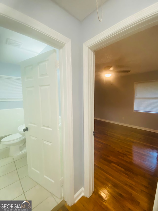 hall with hardwood / wood-style floors