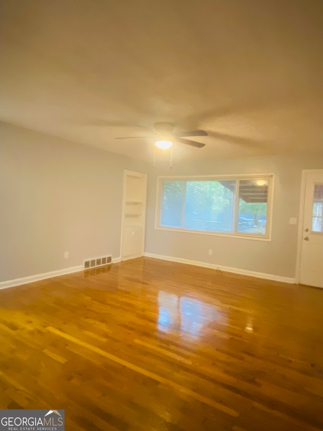 interior space with ceiling fan and wood-type flooring