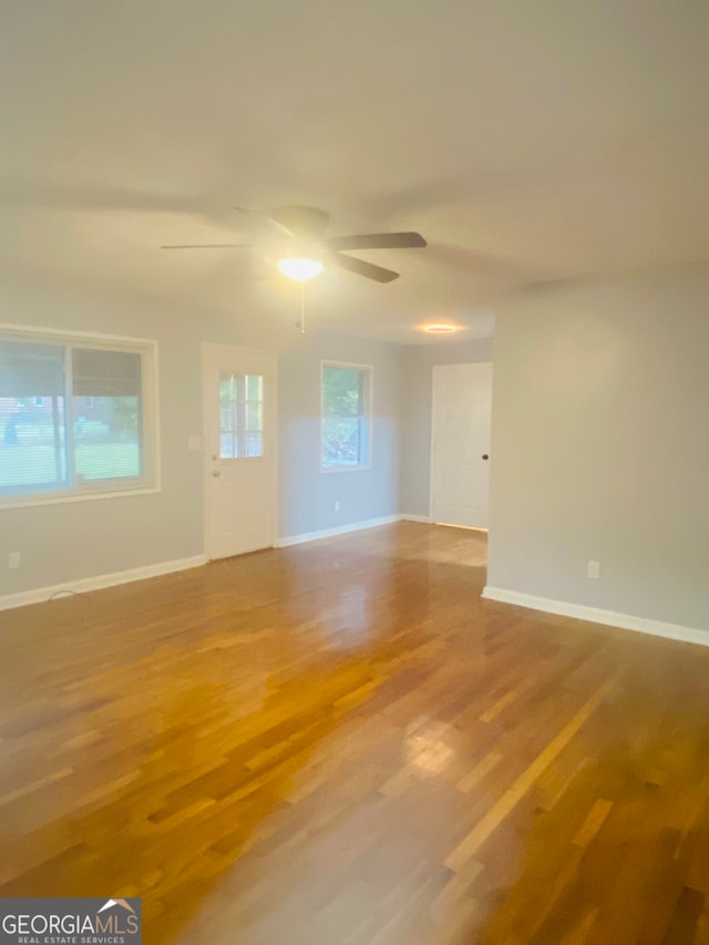 spare room with hardwood / wood-style floors and ceiling fan