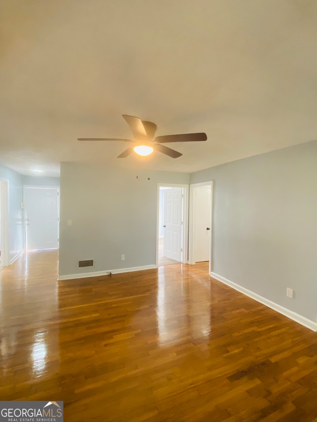 unfurnished room with wood-type flooring and ceiling fan