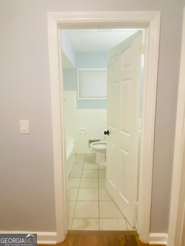 hall featuring light tile patterned floors