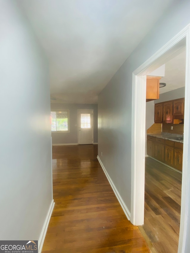 hall with dark hardwood / wood-style flooring