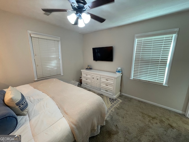 bedroom with ceiling fan and light carpet