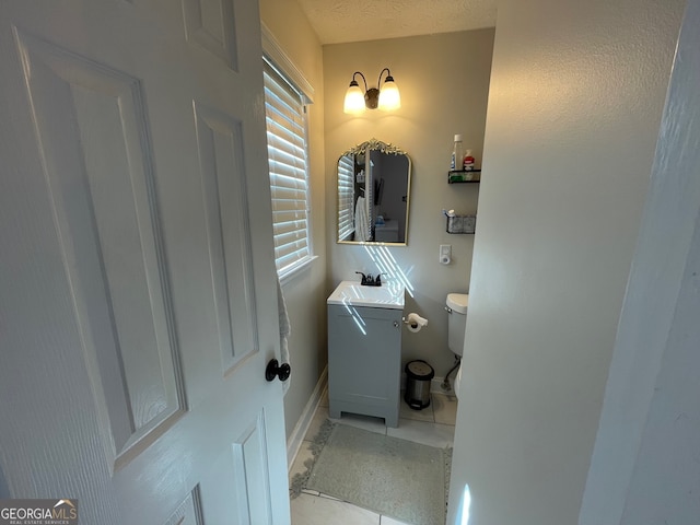 bathroom featuring vanity, toilet, and tile patterned floors