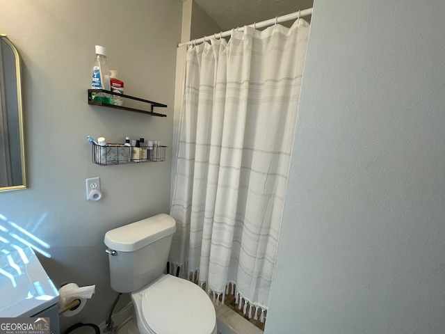 bathroom with toilet and walk in shower