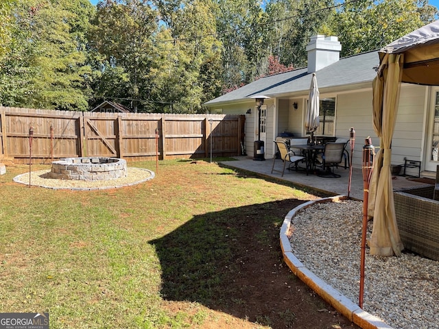 view of yard with an outdoor fire pit and a patio area