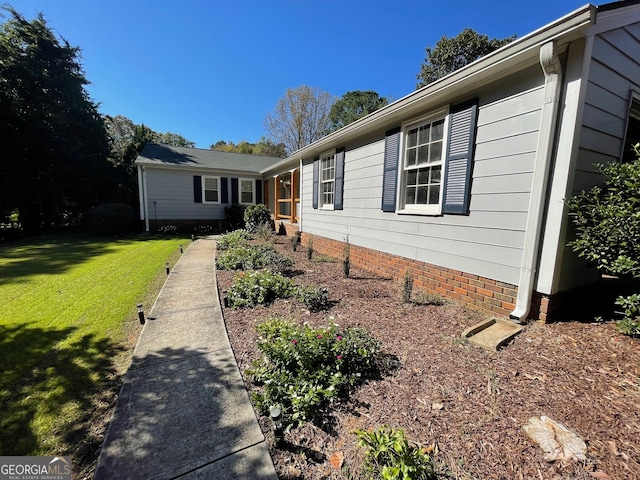 view of property exterior featuring a lawn