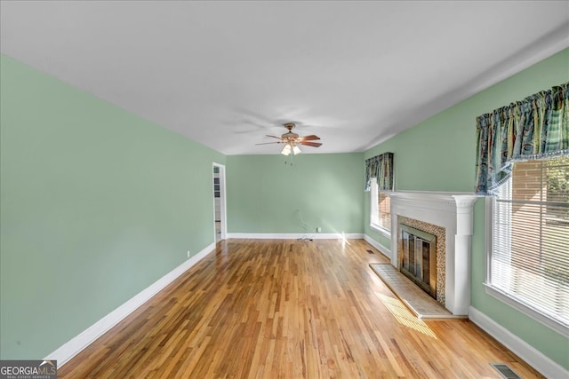 unfurnished living room featuring ceiling fan and light hardwood / wood-style flooring