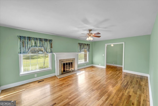 unfurnished living room with hardwood / wood-style floors and ceiling fan