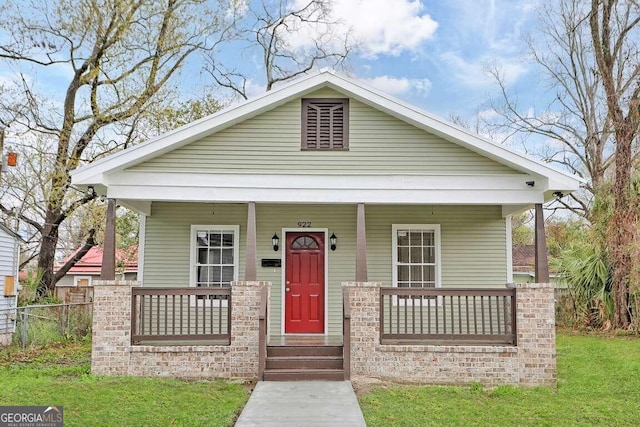 bungalow-style home featuring a front yard and a porch