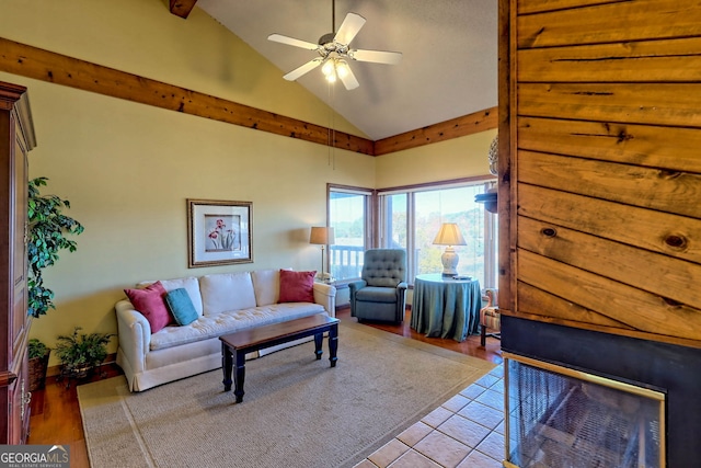 living room featuring light hardwood / wood-style flooring, high vaulted ceiling, and ceiling fan