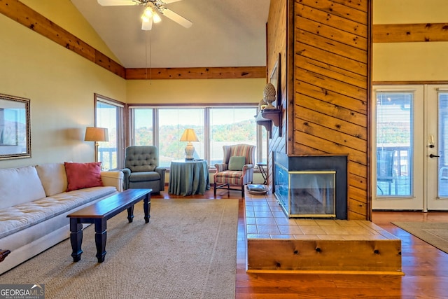 living room featuring lofted ceiling, hardwood / wood-style floors, french doors, and ceiling fan