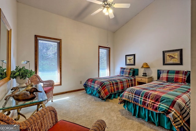 carpeted bedroom featuring multiple windows, high vaulted ceiling, and ceiling fan