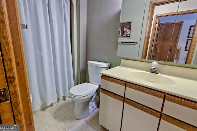 bathroom with vanity, toilet, tile patterned floors, and curtained shower