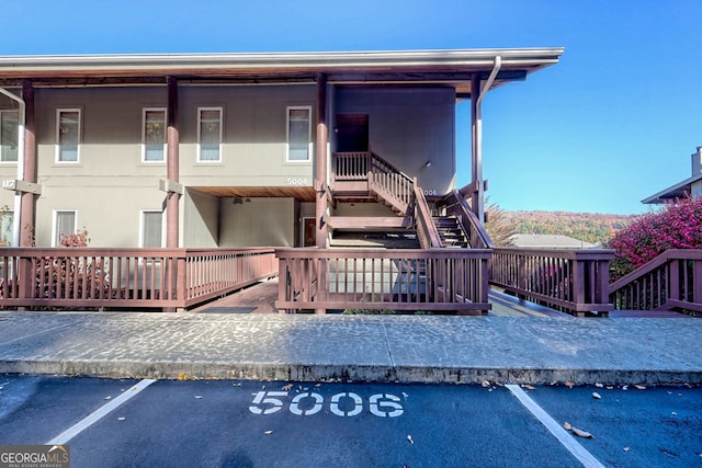 back of house with a wooden deck