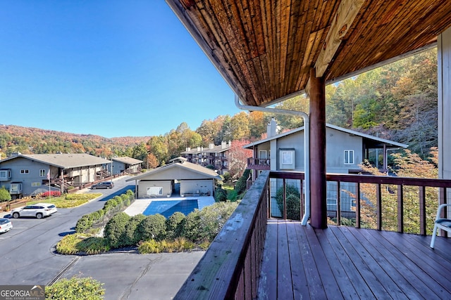 wooden deck featuring a mountain view and a garage