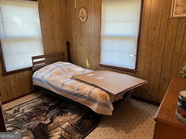 bedroom with wood walls