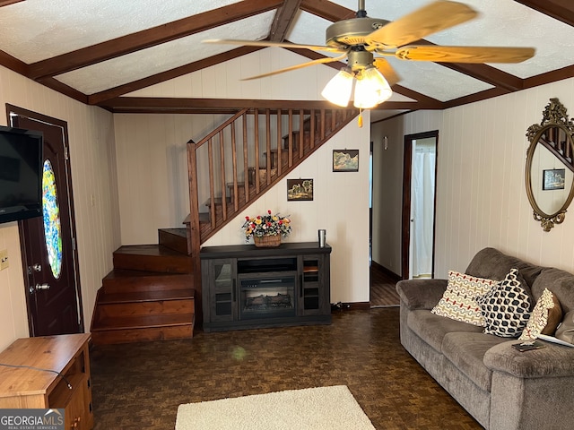 living room with vaulted ceiling with beams, a textured ceiling, and ceiling fan