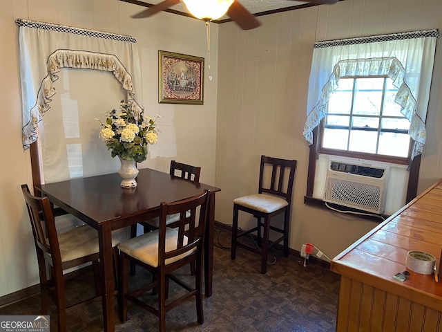 dining room featuring dark parquet floors, cooling unit, wooden walls, and ceiling fan