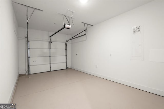 garage with a garage door opener and electric panel