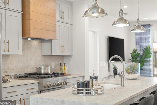 kitchen with white cabinetry, light stone countertops, high end stove, and hanging light fixtures