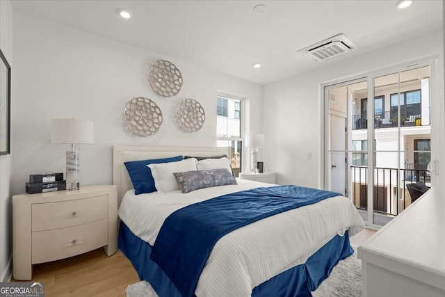 bedroom with light wood-type flooring and access to exterior