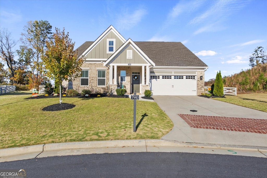 craftsman-style house with a front yard and a garage