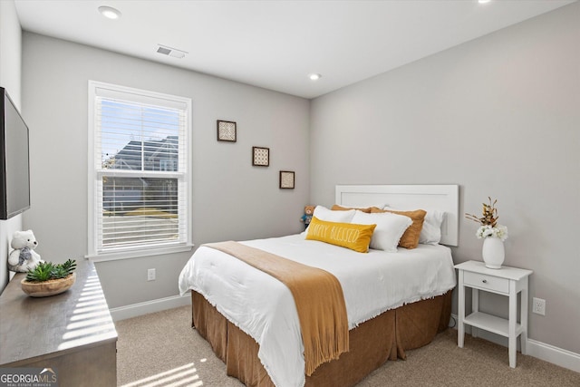 bedroom featuring light carpet