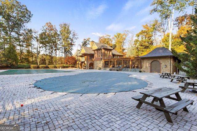 view of pool with an outdoor structure and a patio