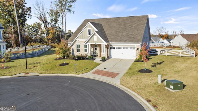 view of front of home with a front lawn and a garage