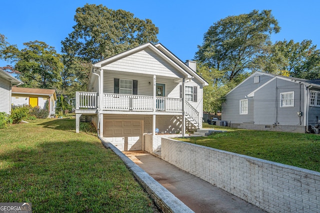 view of front of property featuring a garage, a front lawn, and a porch