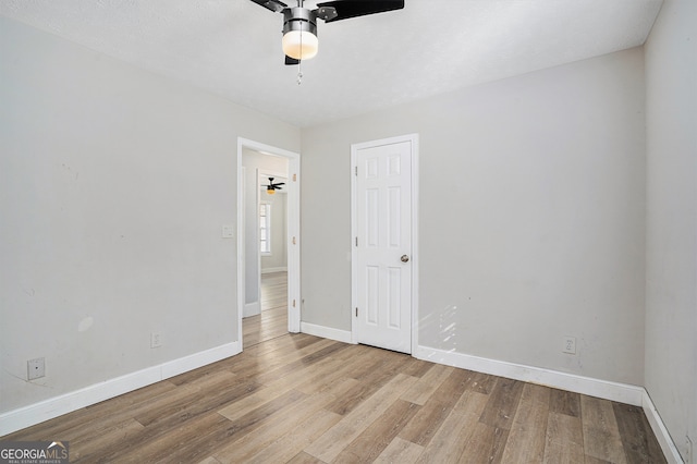 unfurnished room with light hardwood / wood-style flooring and ceiling fan