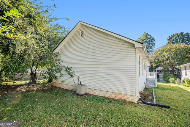 view of property exterior with a lawn