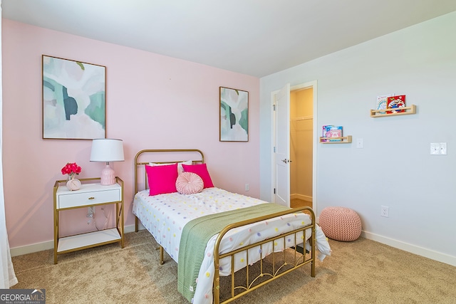 carpeted bedroom with a walk in closet